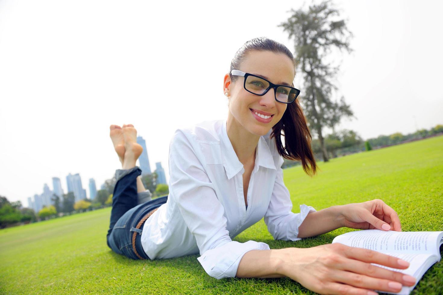 Young woman reading a book in the park photo