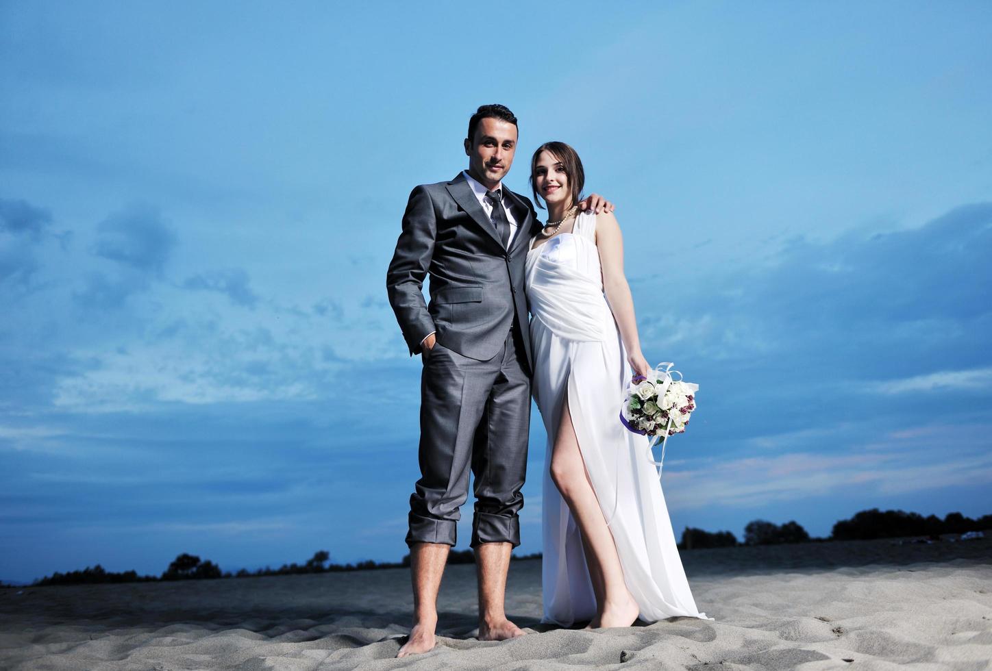 romantic beach wedding at sunset photo