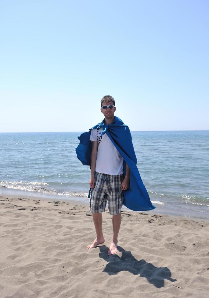 funny superhero standing on beach photo