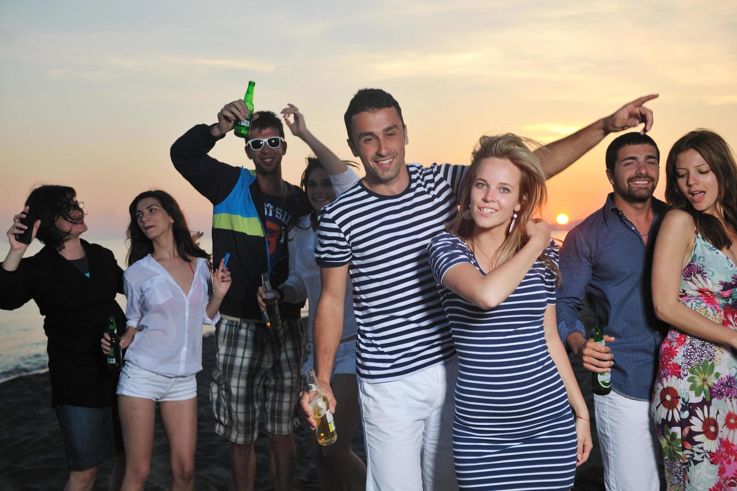 Group of young people enjoy summer  party at the beach photo