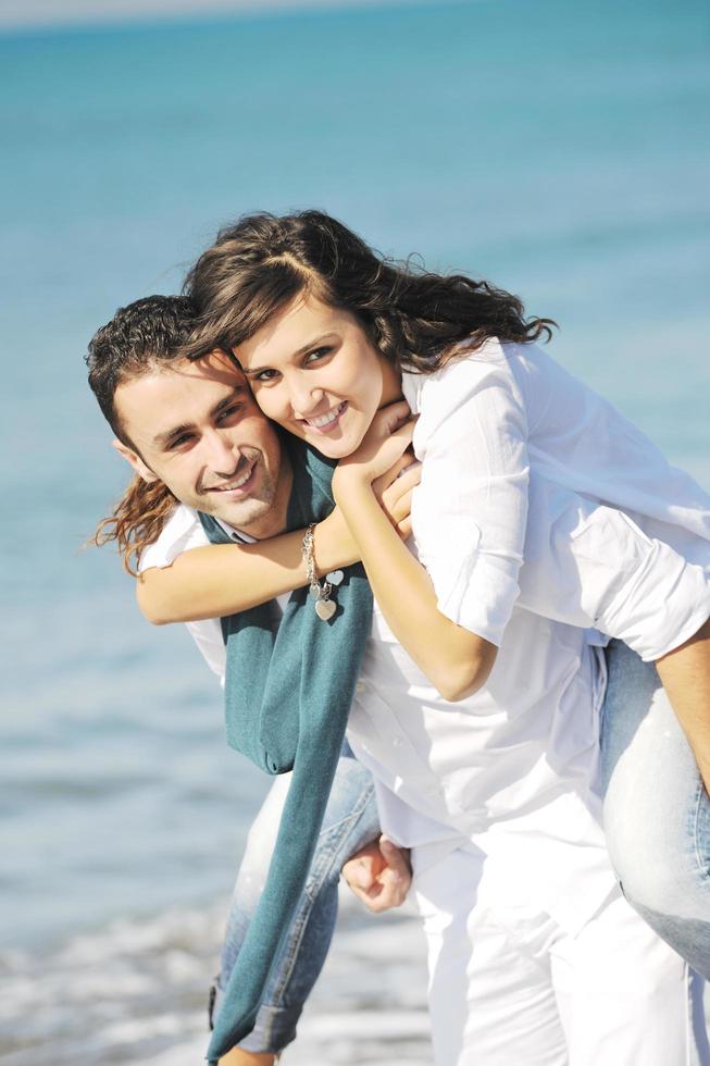 happy young couple have fun at beautiful beach photo