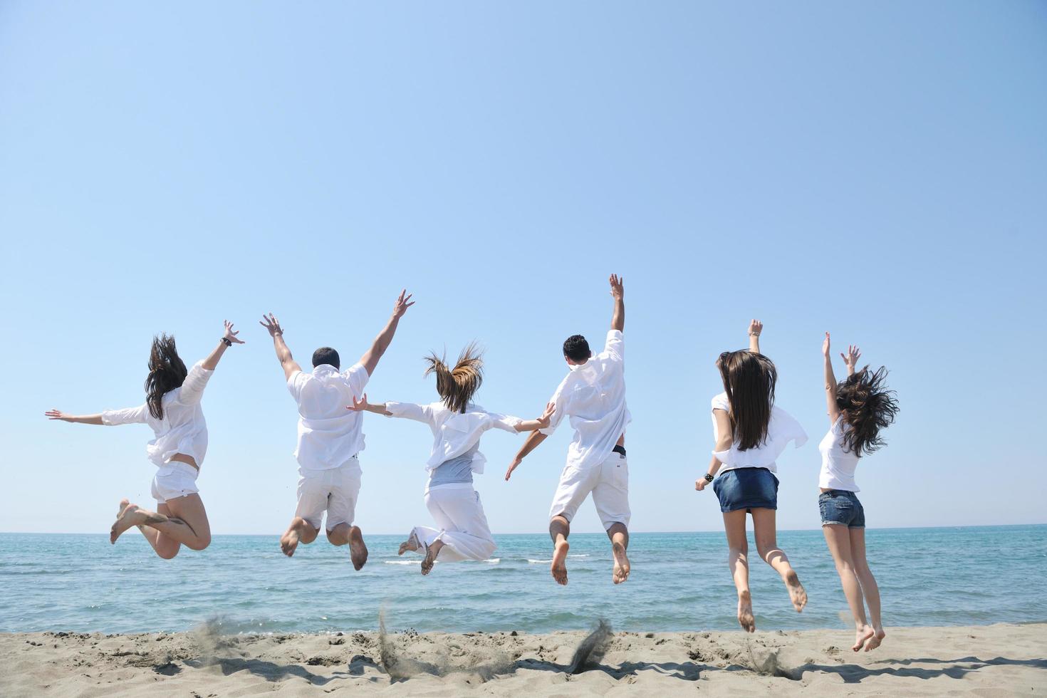 happy people group have fun and running on beach photo