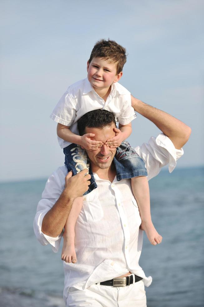 happy father and son have fun and enjoy time on beach photo