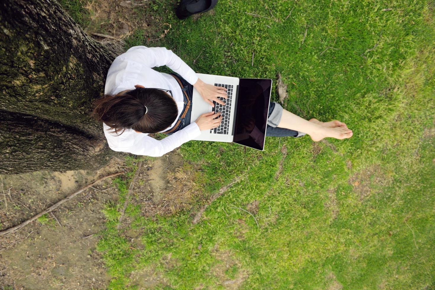 woman with laptop in park photo