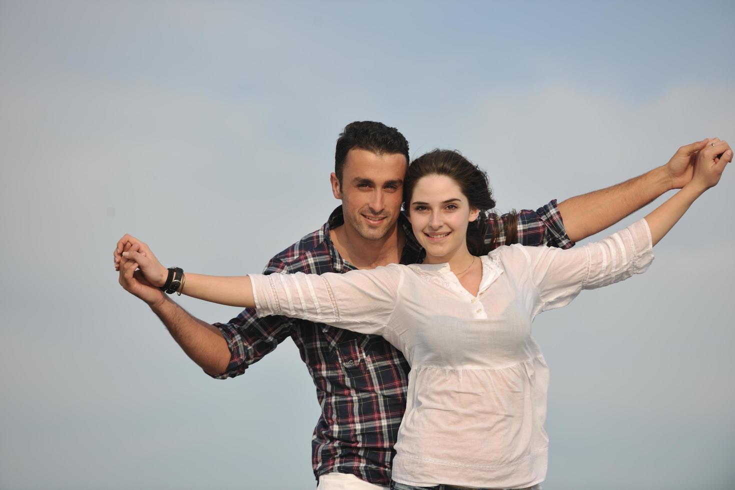 happy young couple have fun on beach photo