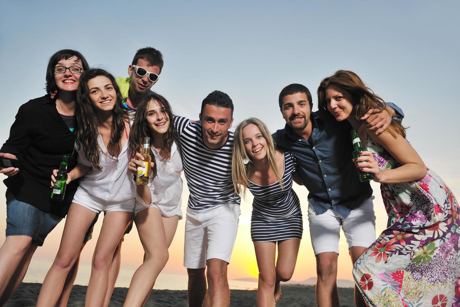 Group of young people enjoy summer  party at the beach photo