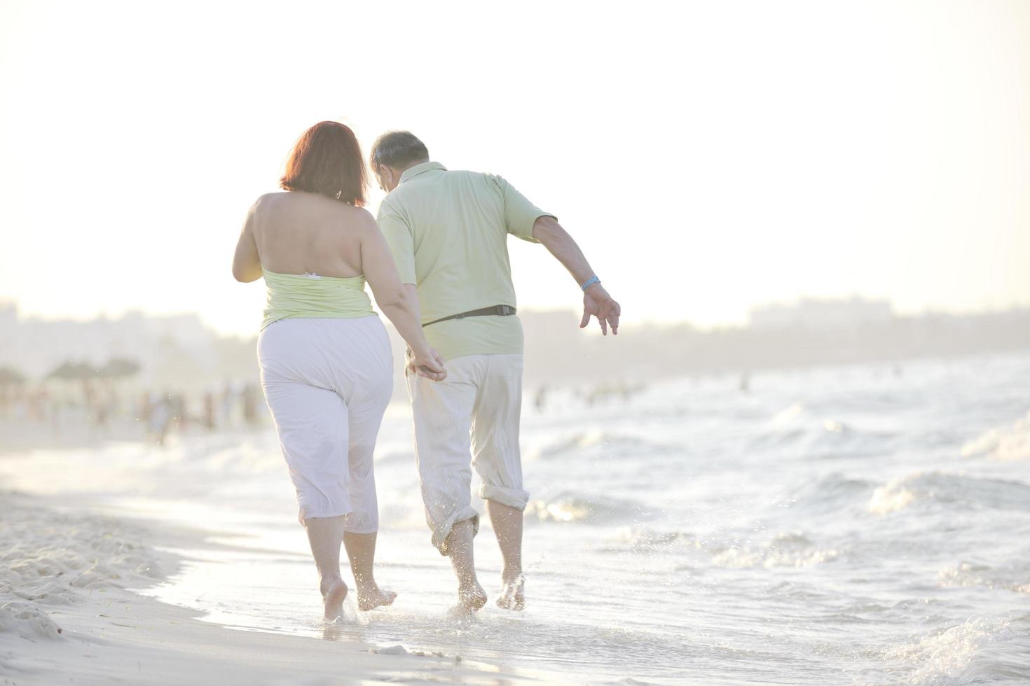 happy seniors couple  on beach photo