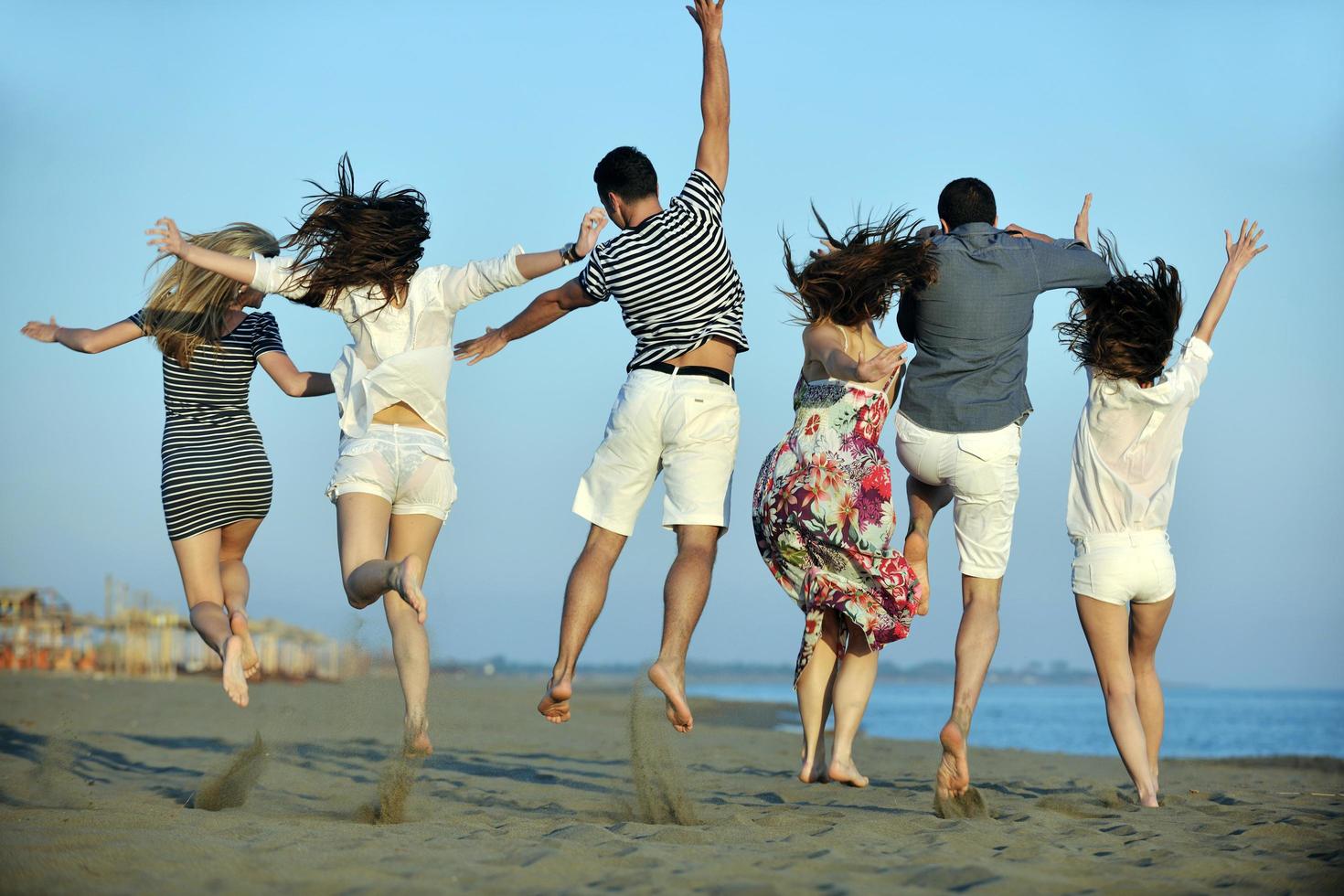 happy young  people group have fun on beach photo