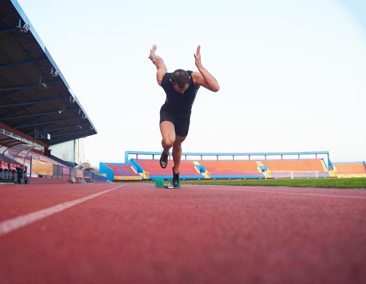 pixelated design of woman  sprinter leaving starting blocks photo