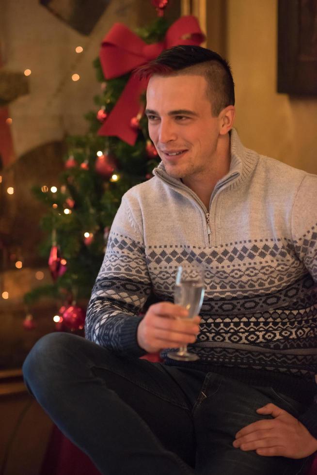 Happy young man with a glass of champagne photo