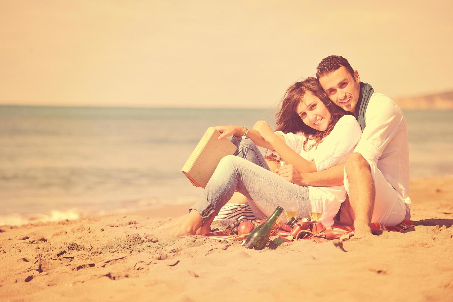 young couple enjoying picnic on the beach 12656226 Stock Photo at Vecteezy