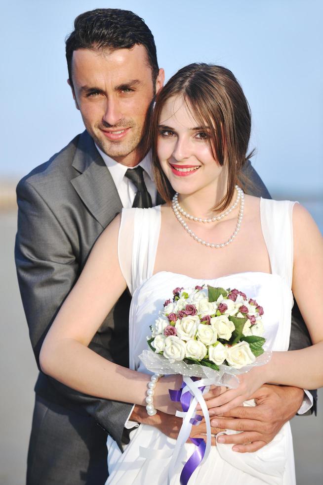 romantic beach wedding at sunset photo