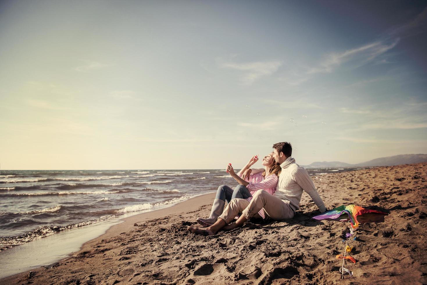 young couple enjoying time together at beach photo