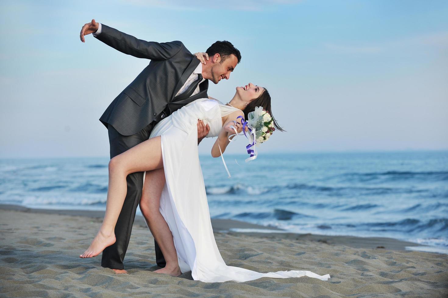 romantic beach wedding at sunset photo