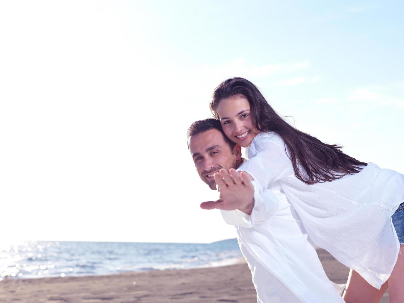 young couple  on beach have fun photo