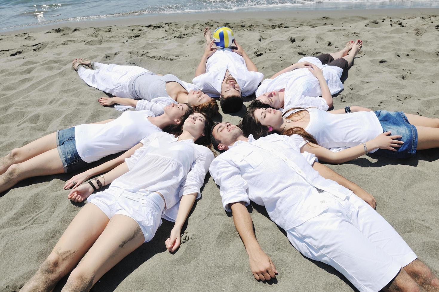 Group of happy young people in have fun at beach photo