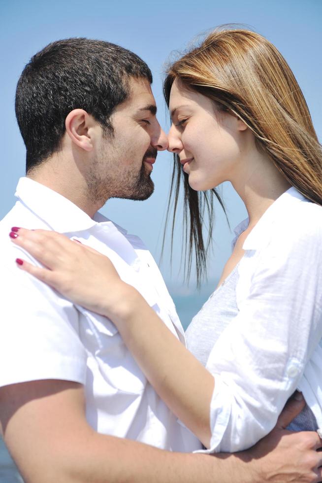 happy young couple have fun on beach photo