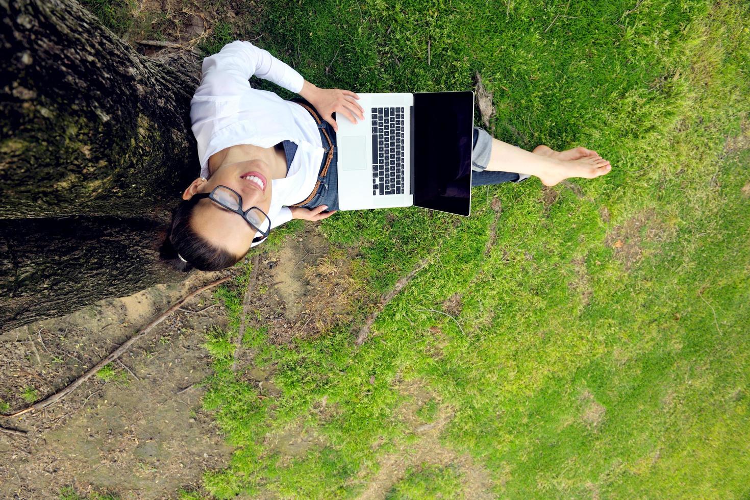 woman with laptop in park photo