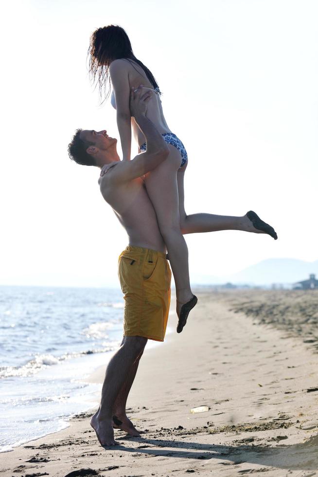 happy young couple have fun on beach photo