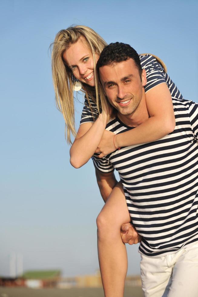happy young couple have romantic time on beach photo