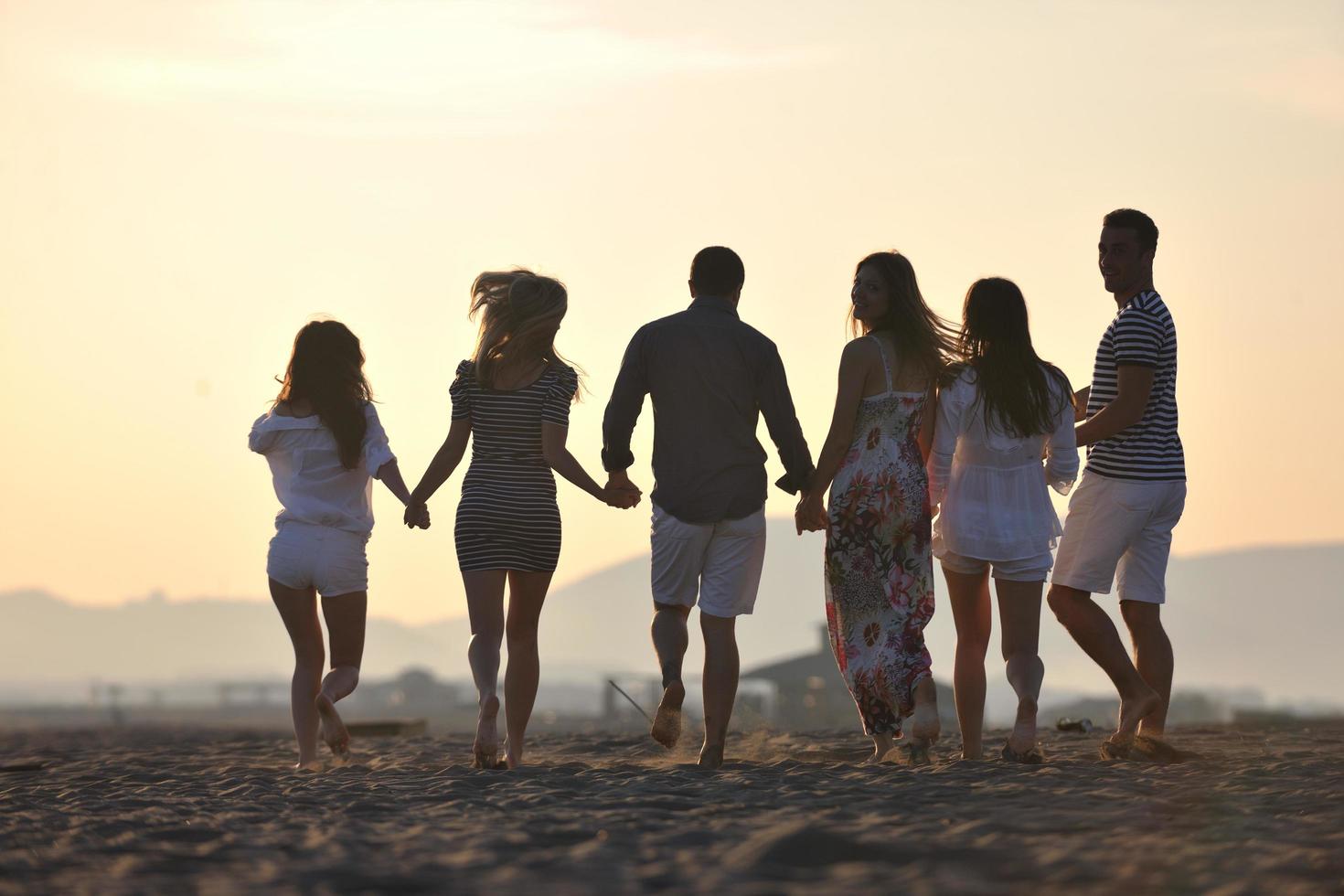 happy young  people group have fun on beach photo