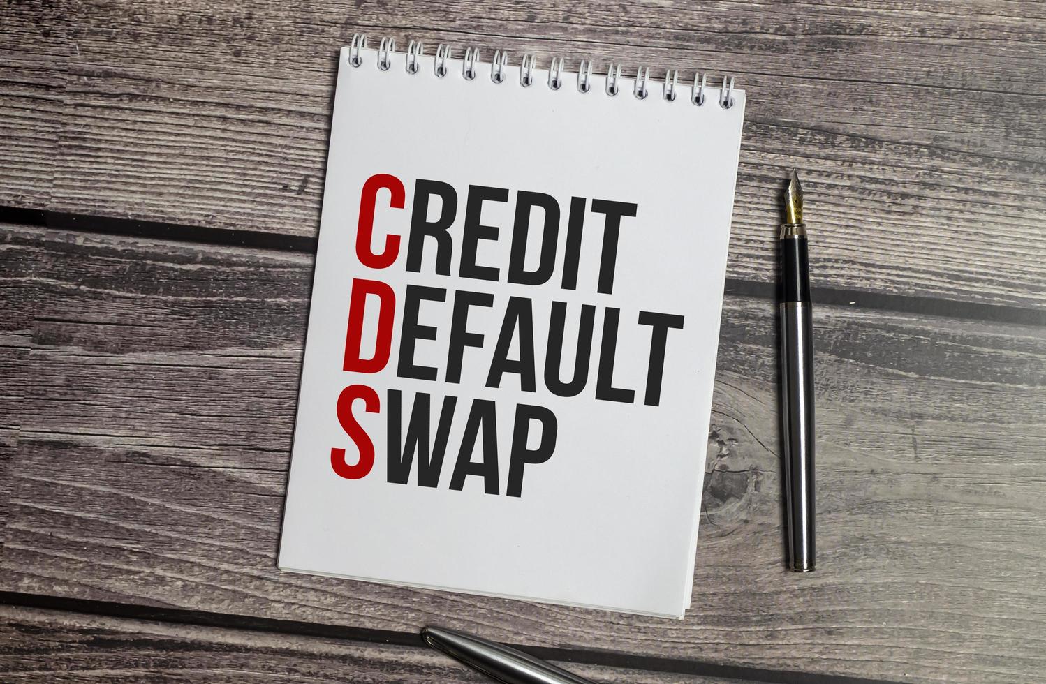 CDS Credit Default Swap text on white paper on wooden background photo