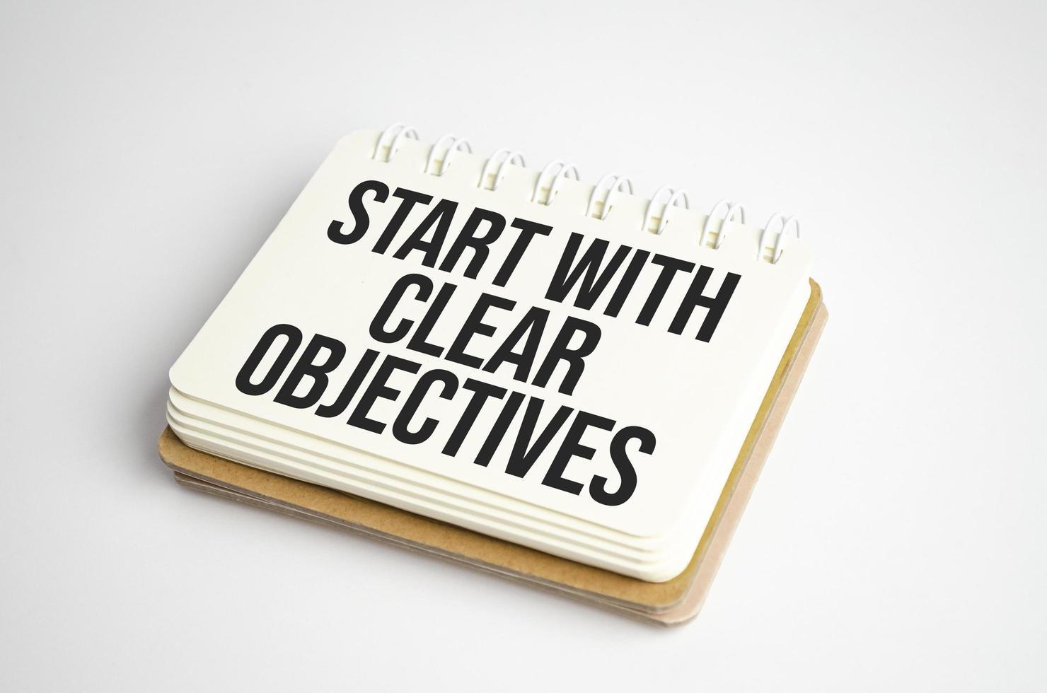 Business concept. Notebook with text START WITH CLEAR OBJECTIVES sheet of white paper photo