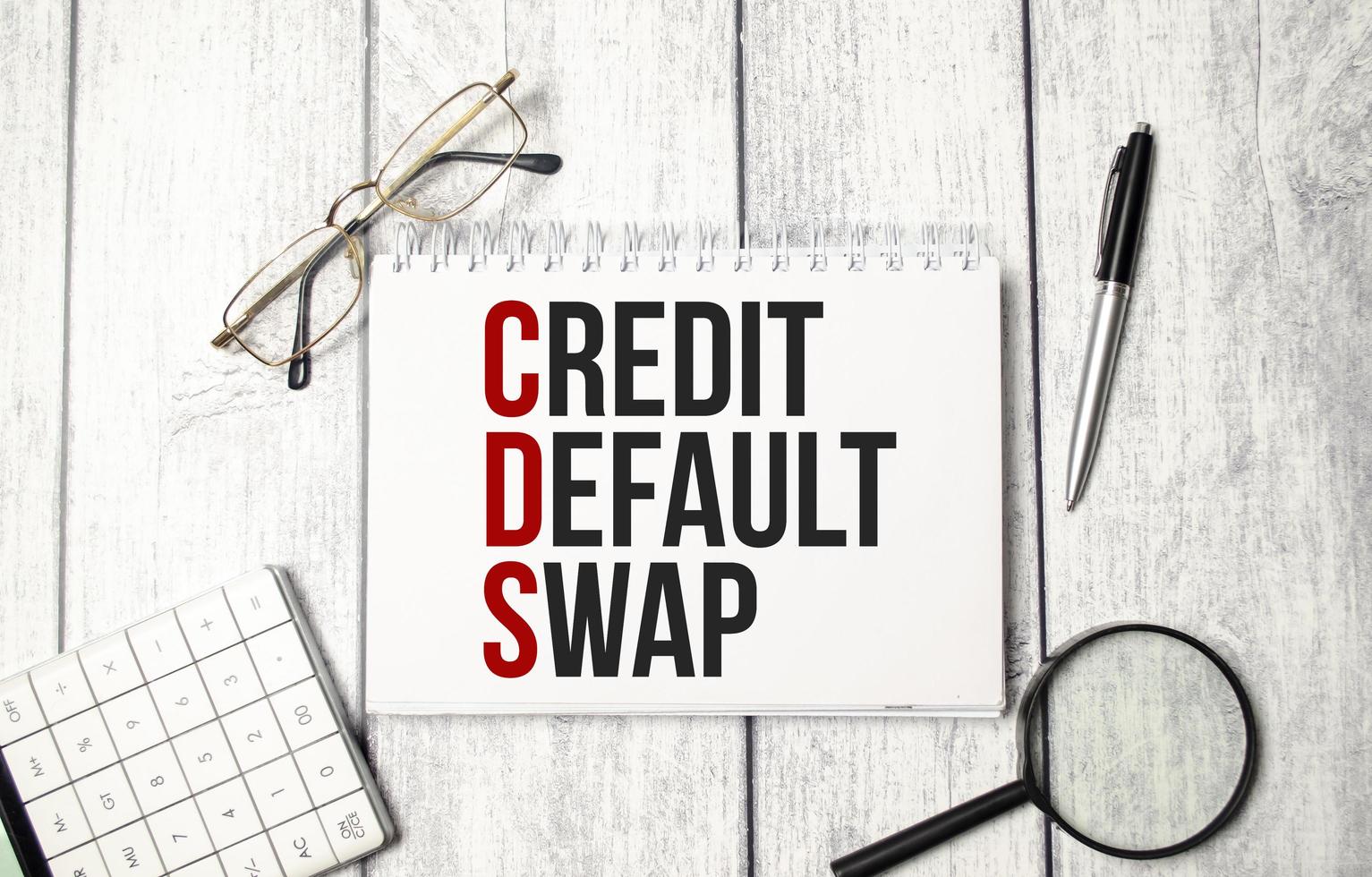 concept word CDS Credit Default Swap on notepad and office supplies photo