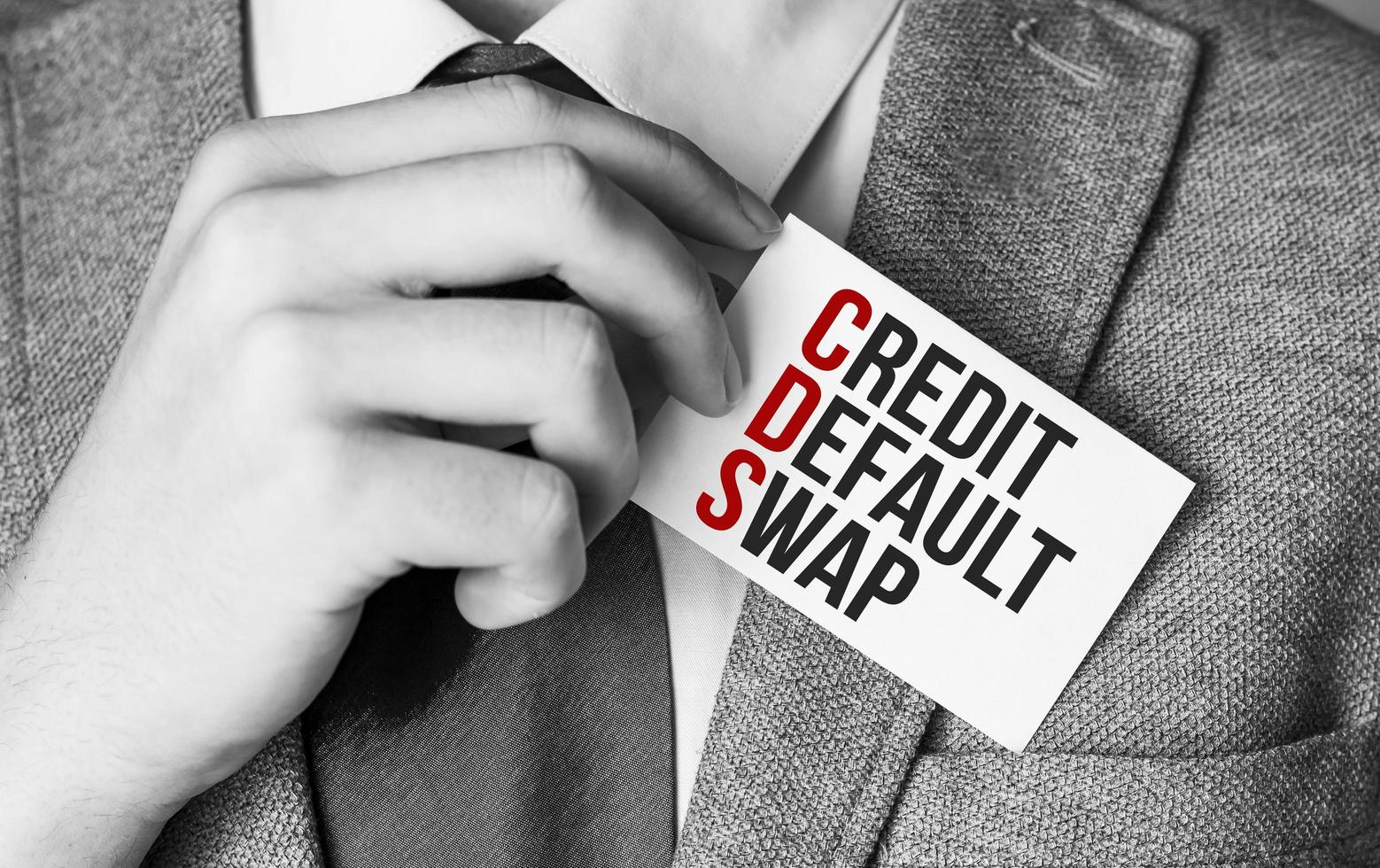 CDS Credit Default Swap - word on business card and businessman hand photo