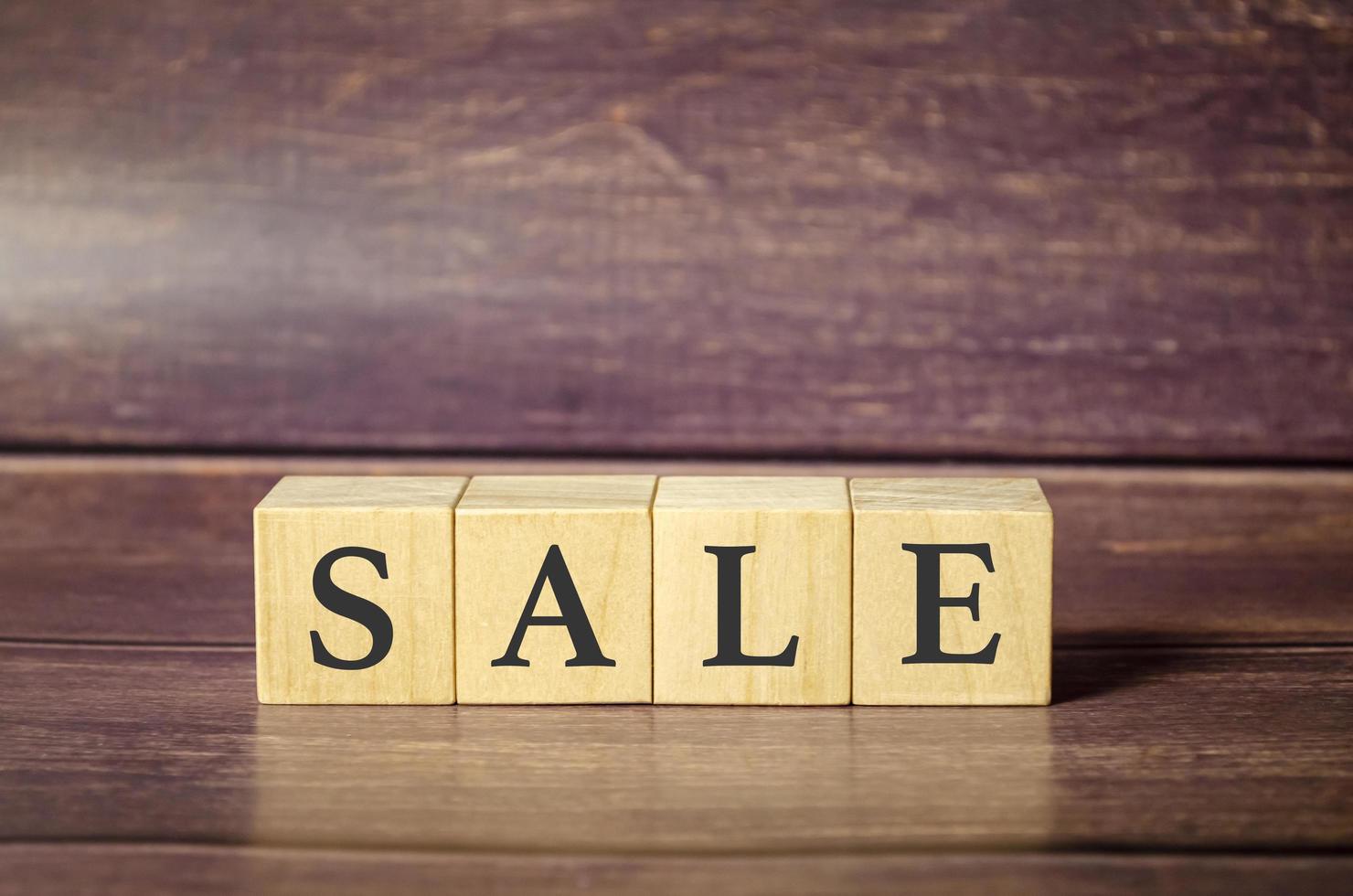 Word sale made from wooden blocks on wooden background photo