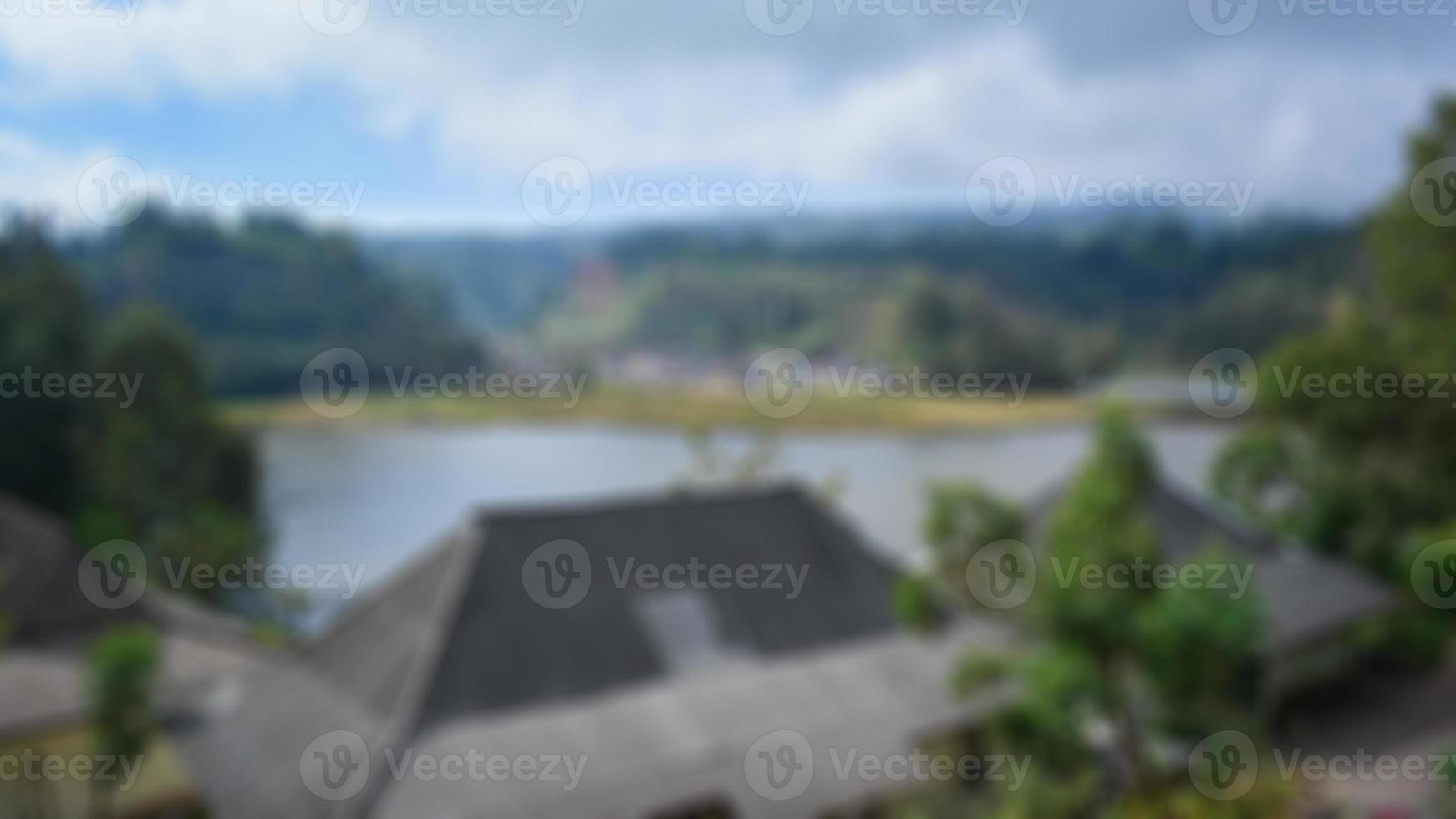 Blurred view of lake ranu kumbolo, semeru mountain. bokeh background in summer, green nature concept photo