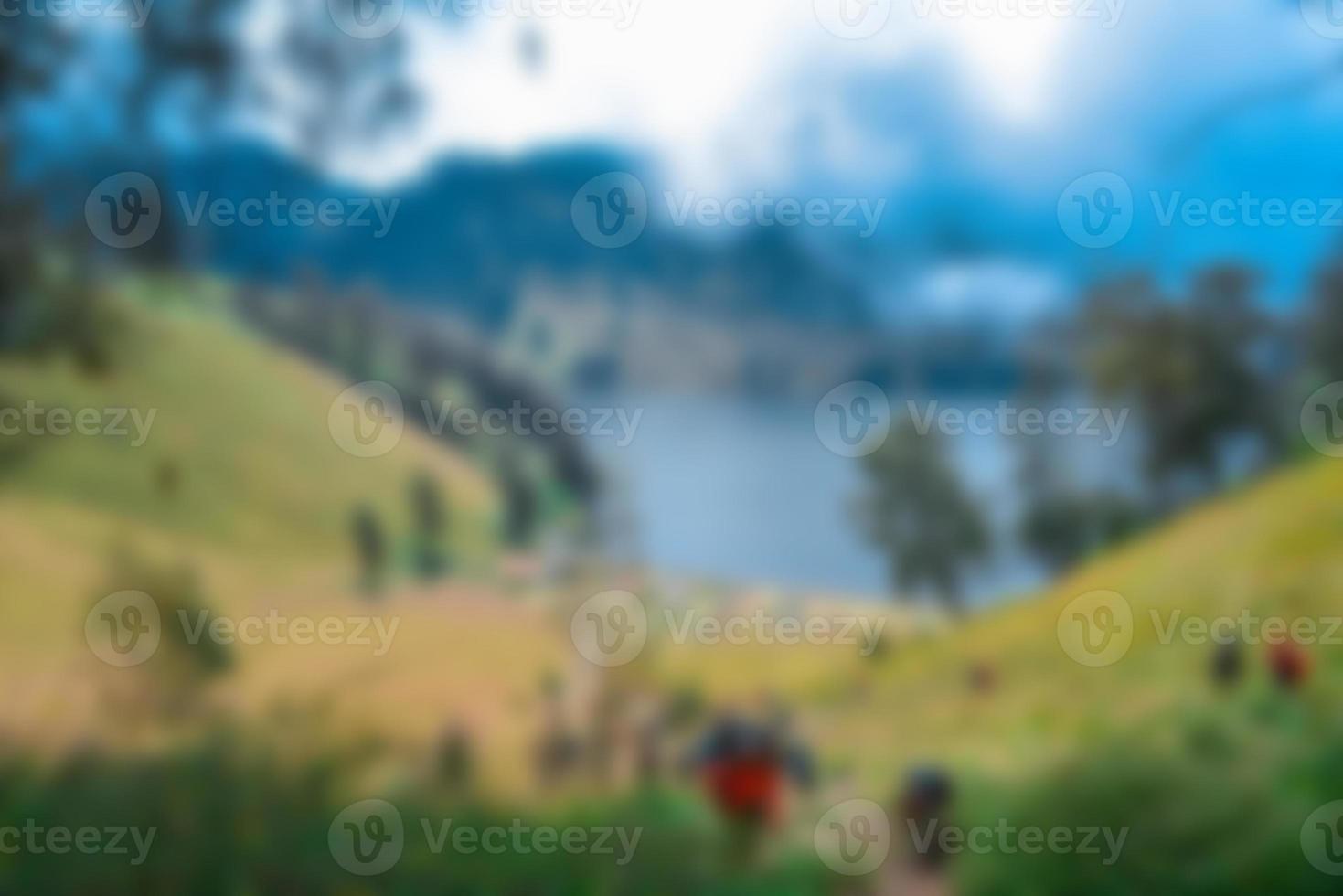 Blurred view of lake ranu kumbolo, semeru mountain. bokeh background in summer, green nature concept photo