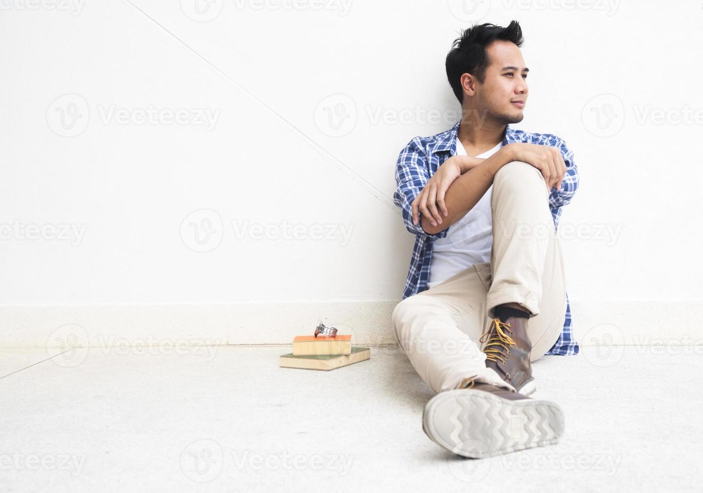 A man is sitting in a relax position. photo