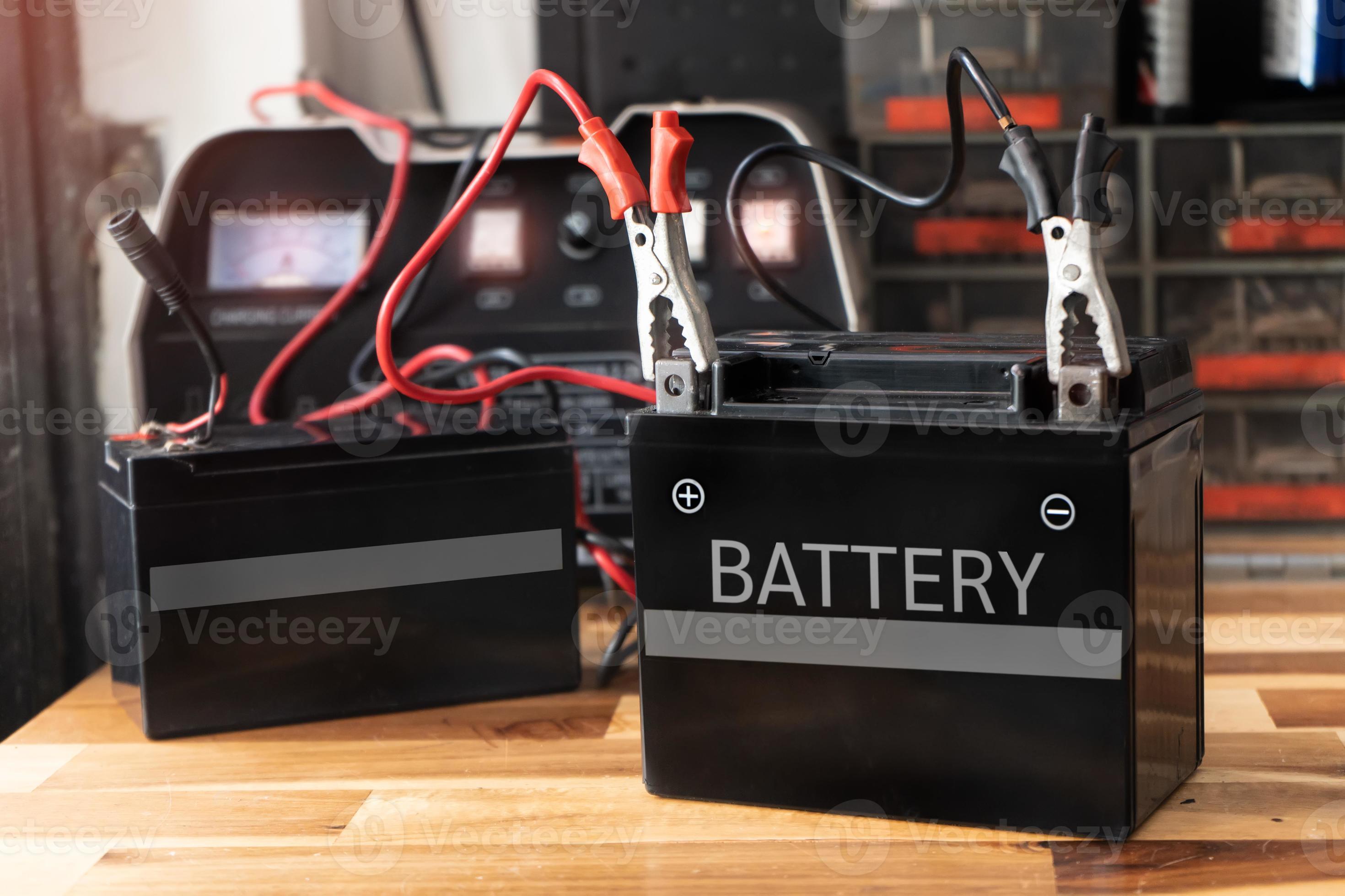 Charging motorcycle battery at garage,concept of motorcycle maintenance