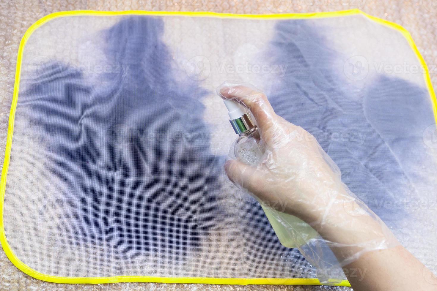 craftsman wetting first layer of fibers by spray photo