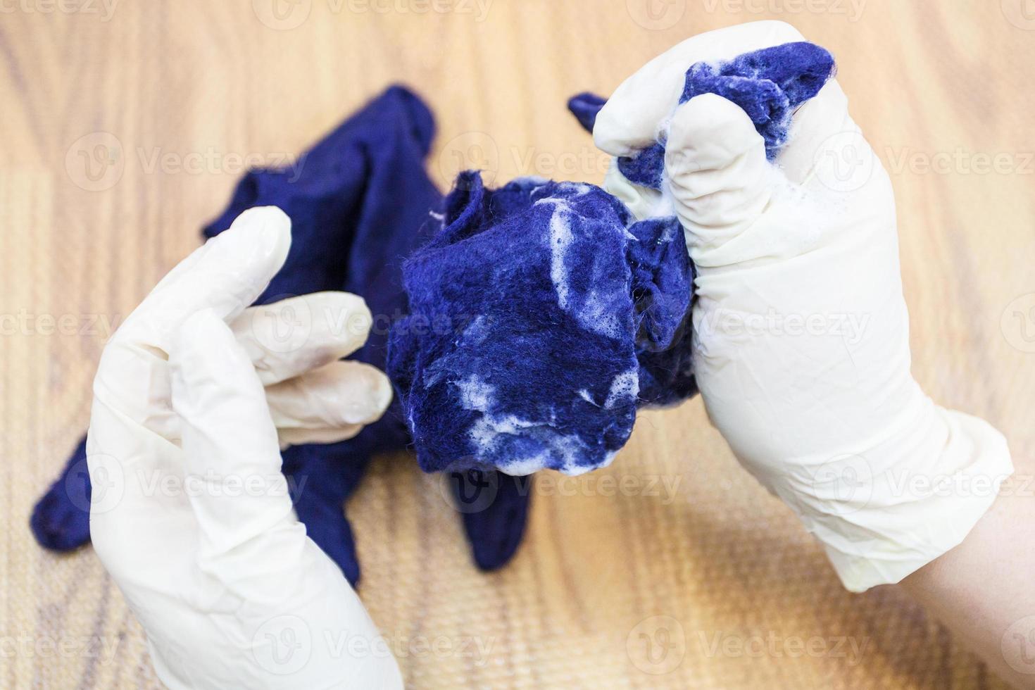 craftsman fulling the felted glove with soap water photo