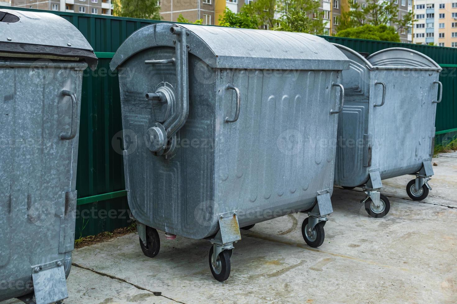 metal trash cans for separate waste collection in a densely populated area of the city photo