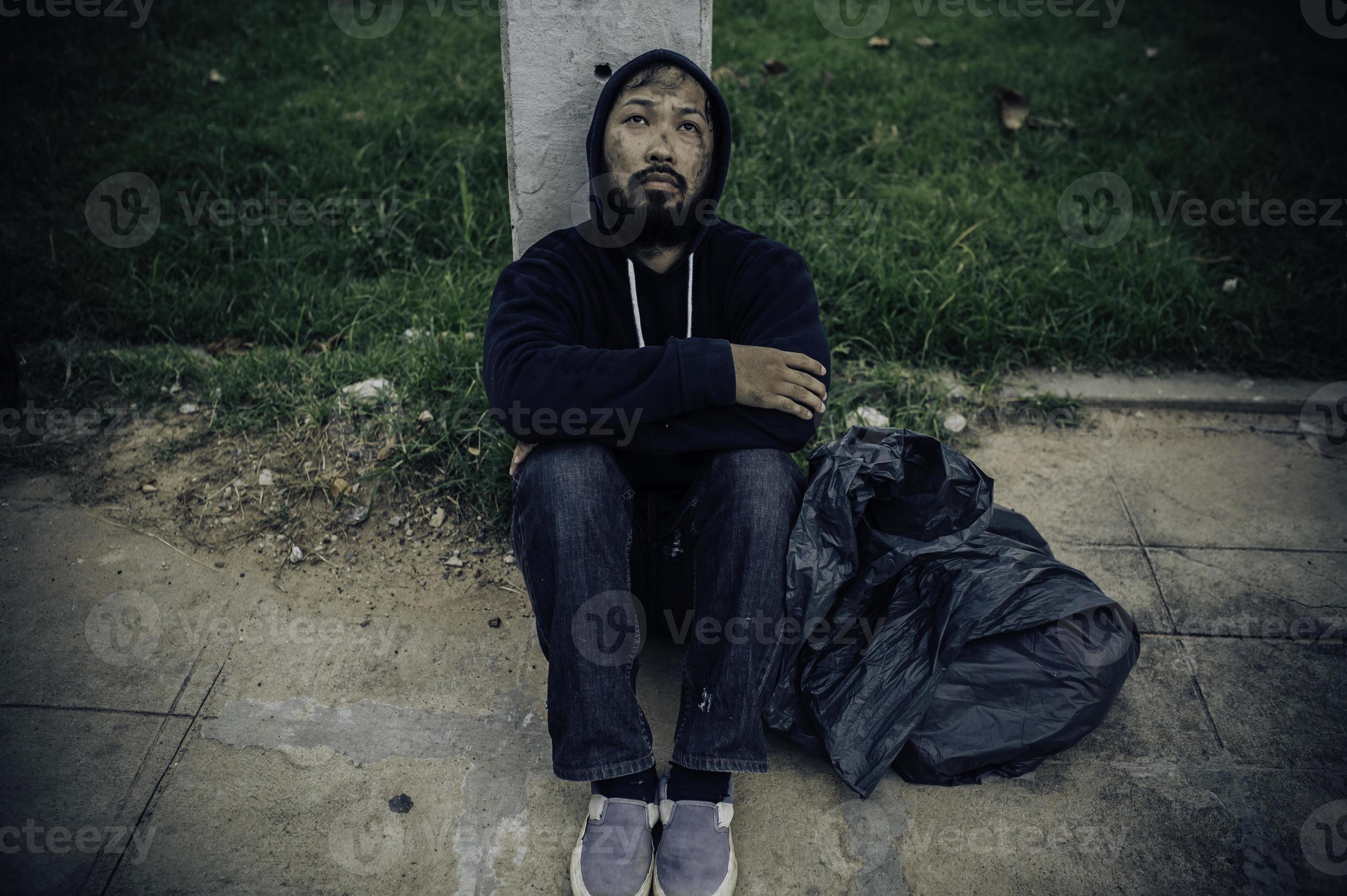 Asian man is homeless at the side road,A stranger has to live on the road alone because he has