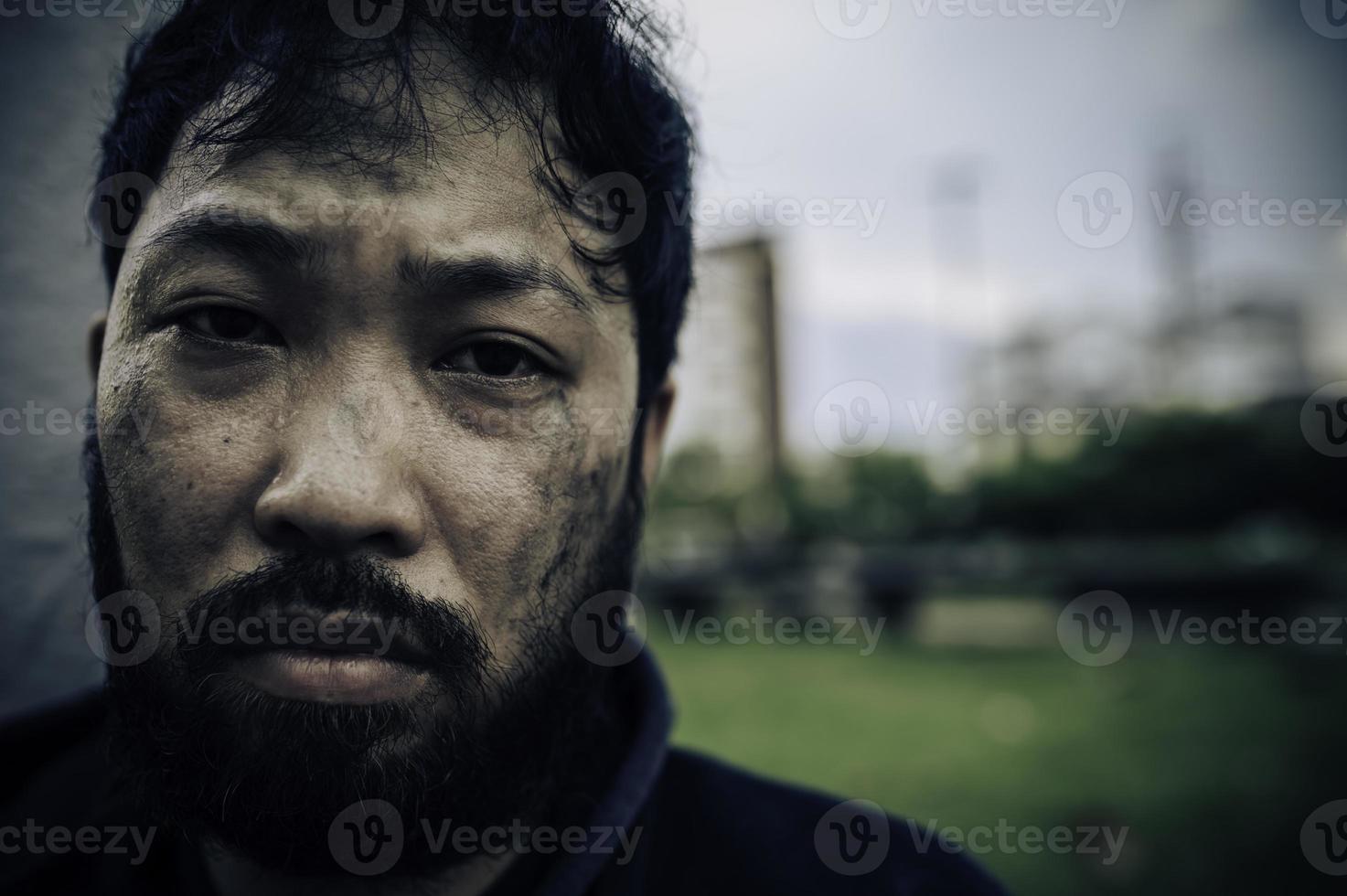 Asian man is homeless at the side road,A stranger has to live on the road alone because he has no family. photo