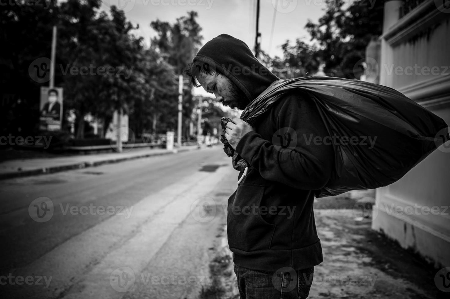 Asian man is homeless at the side road,A stranger has to live on the road alone because he has no family. photo