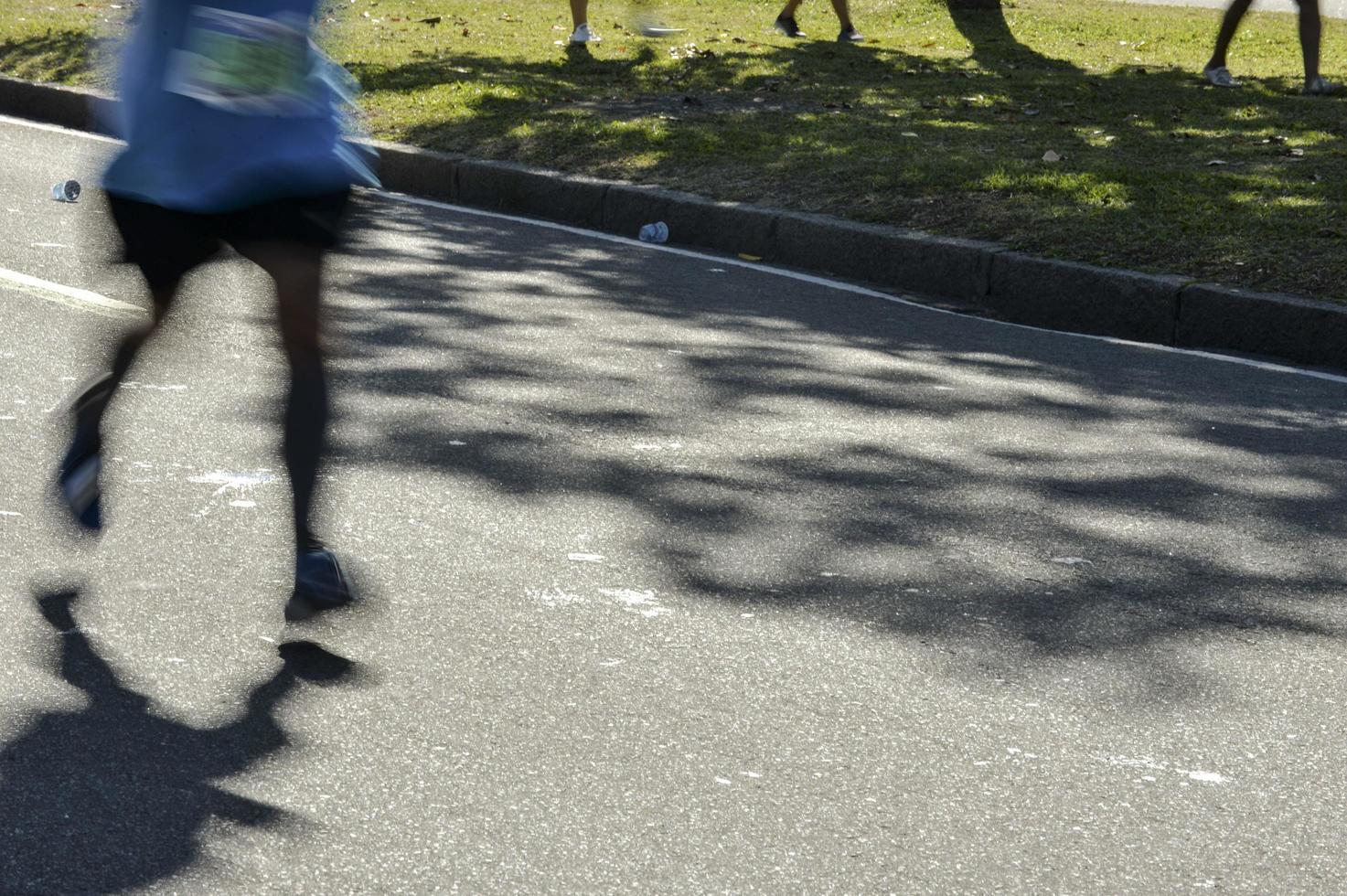 Street race, showing the blurs motion legs of the runners photo