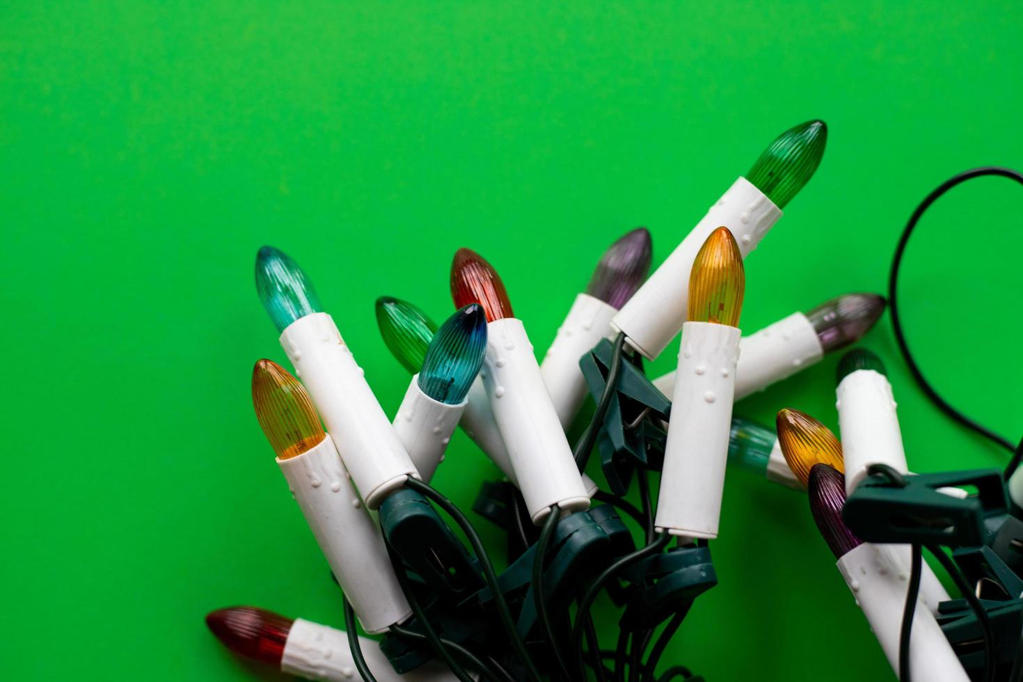 Christmas lights on a green background photo