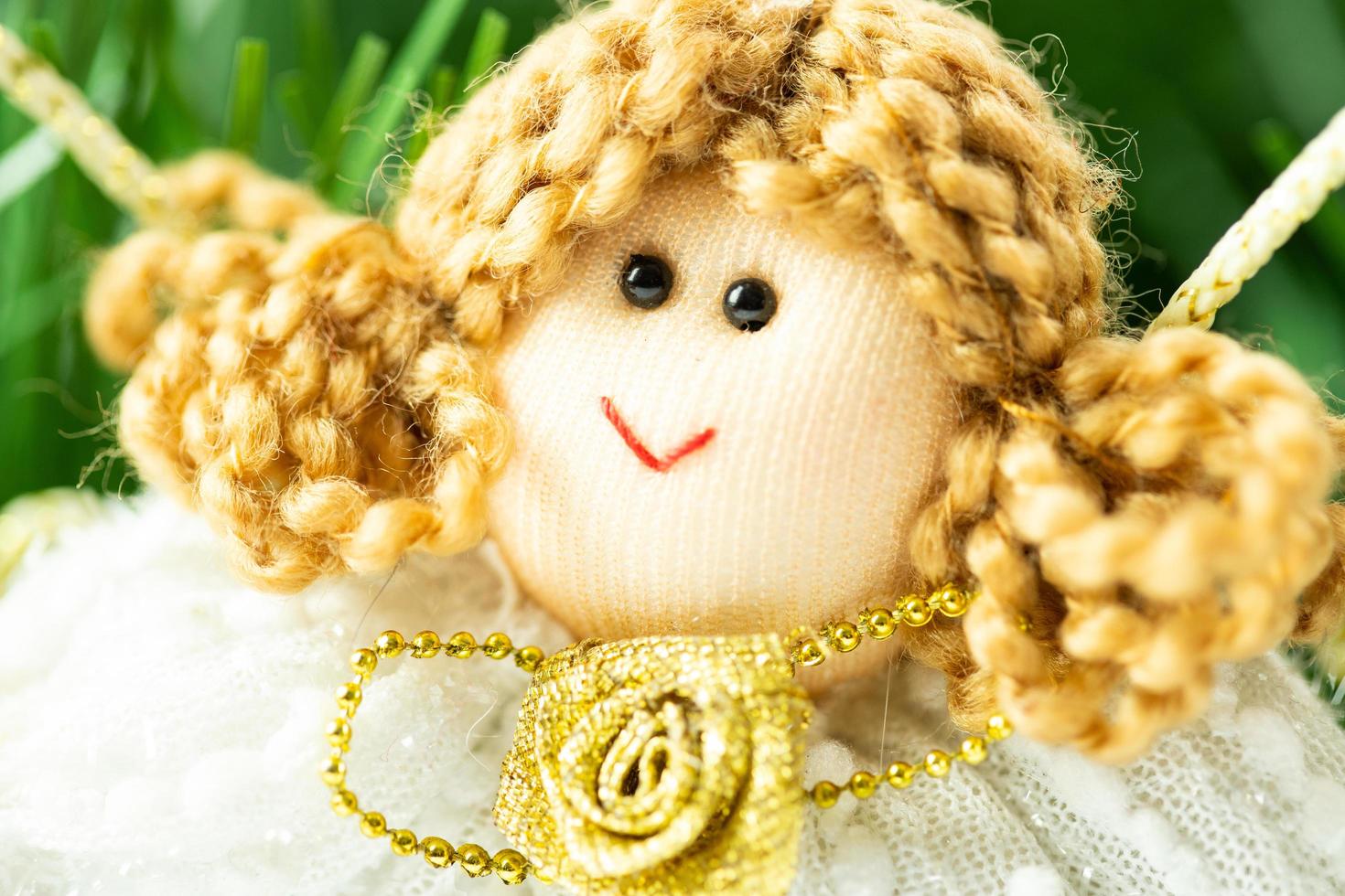 Face of a handmade fabric Christmas angel. An original Christmas ornament that represents happiness. photo