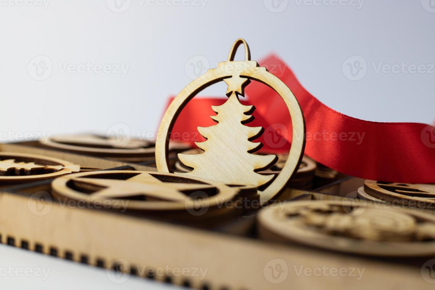 Wooden Christmas tree ornament with a red ribbon photo