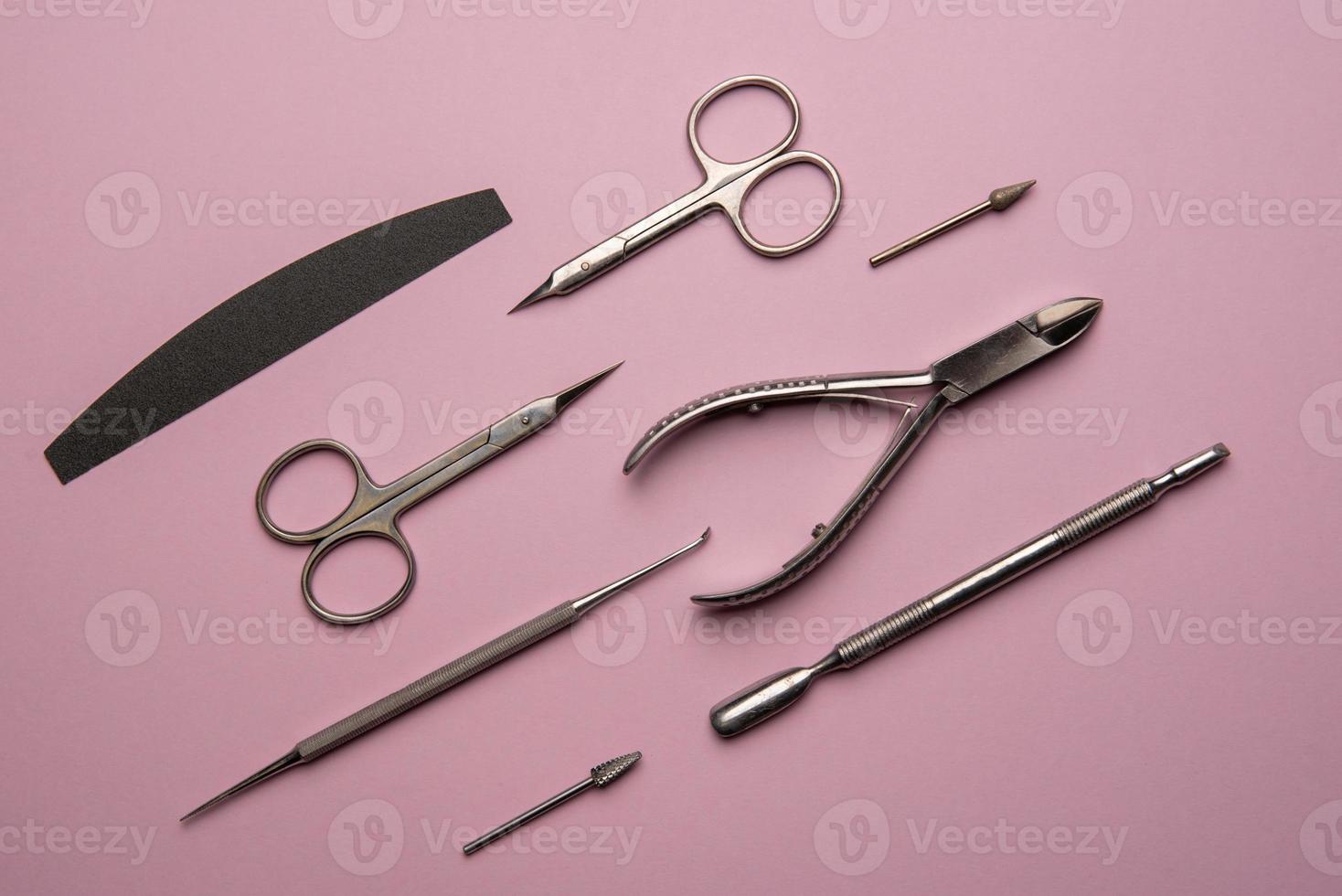 Set of manicure tools and accessories on a pink background. Hardware manicure,Flat lay. photo