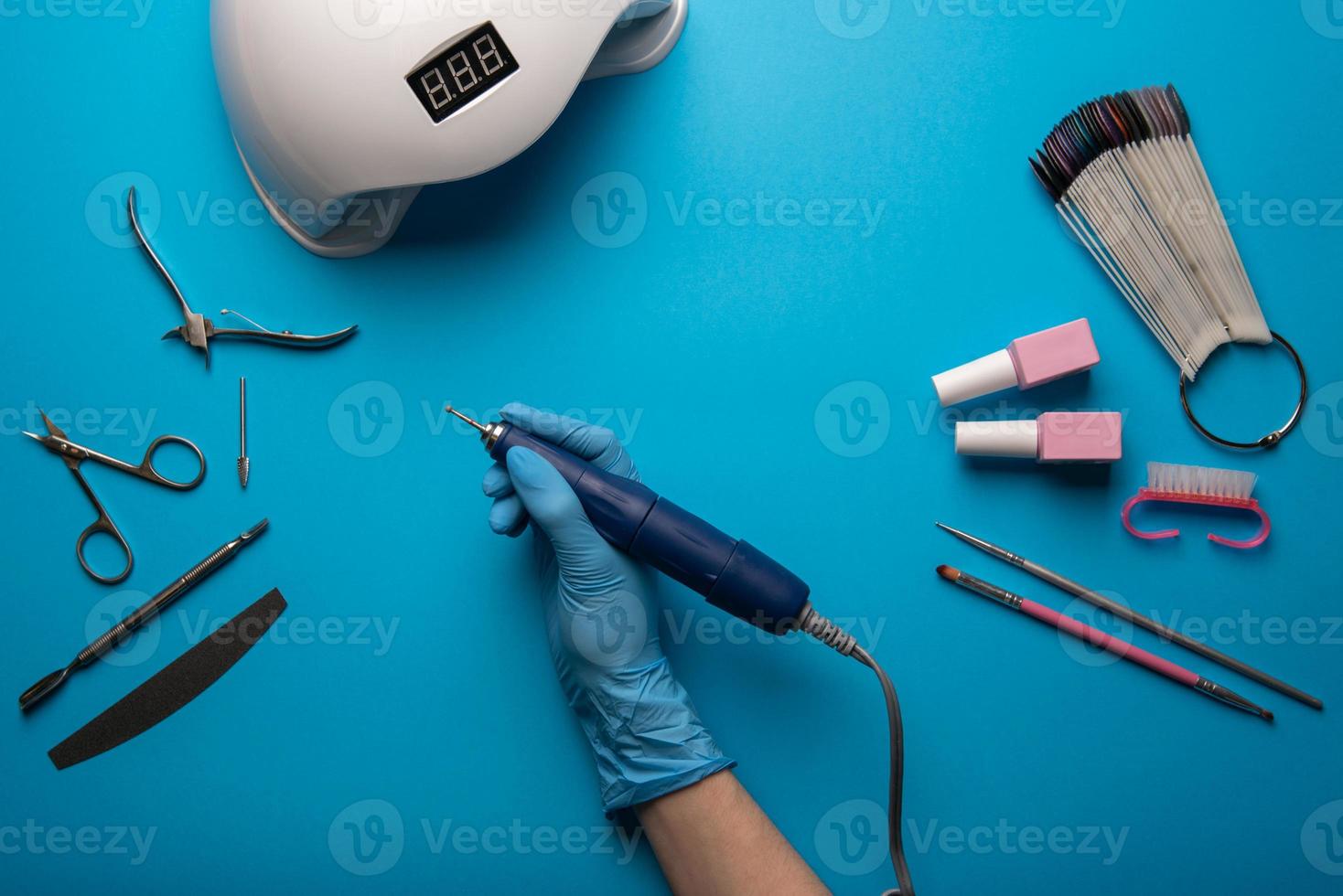 Set of manicure tools and accessories on a blue background. Hardware manicure,Flat lay. photo