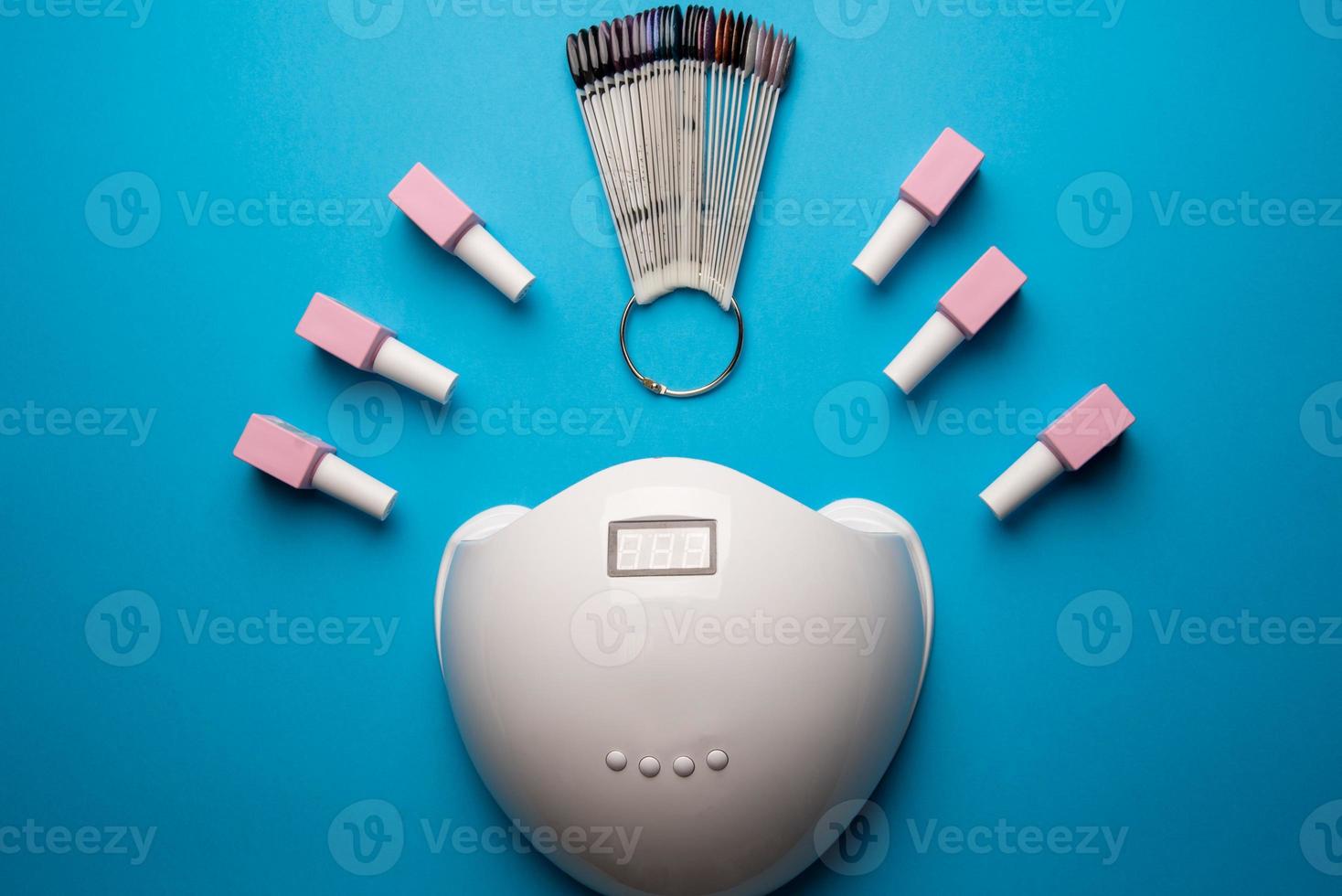 Set of manicure tools and accessories on a blue background. Hardware manicure,Flat lay. photo