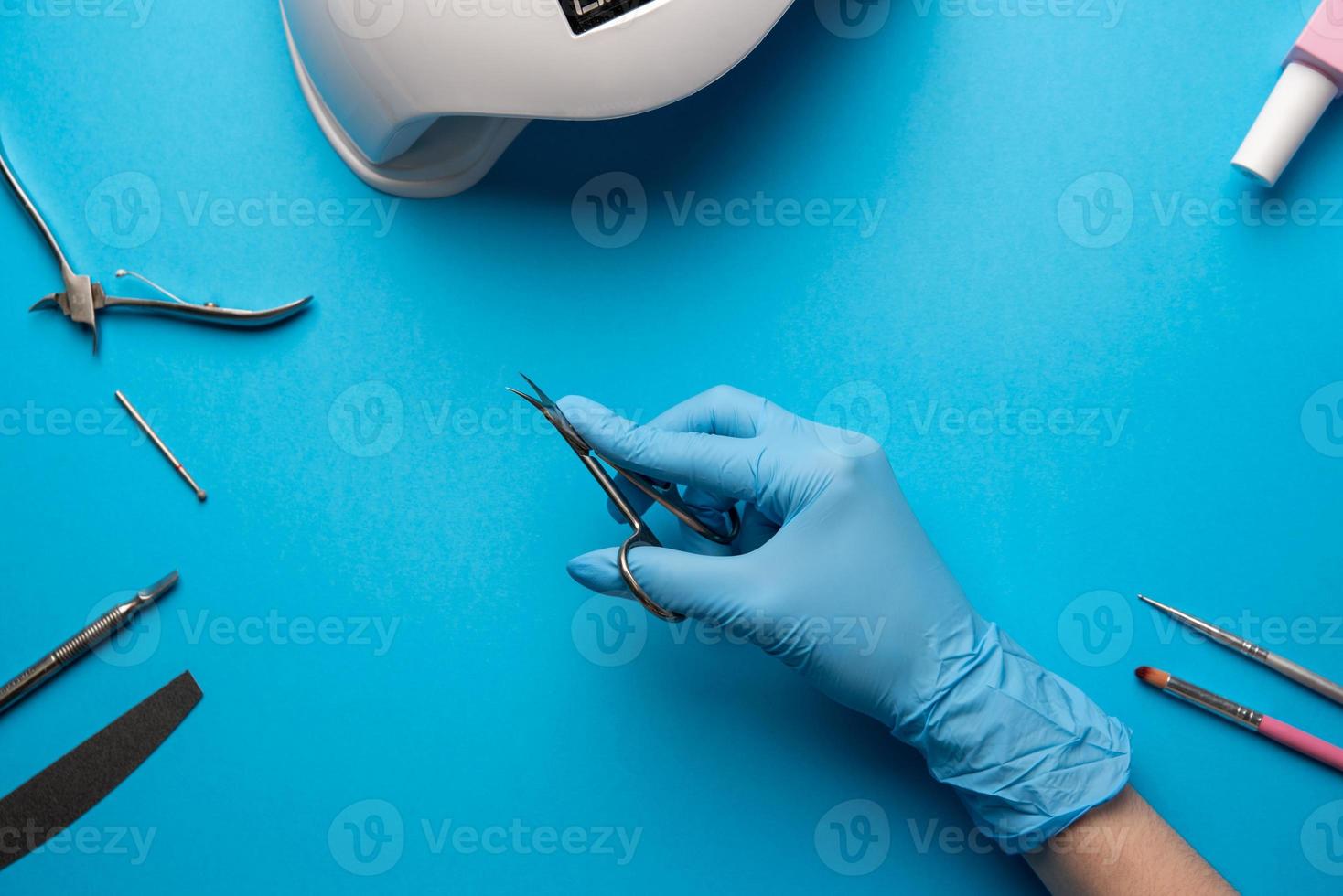 Set of manicure tools and accessories on a blue background. Hardware manicure,Flat lay. photo