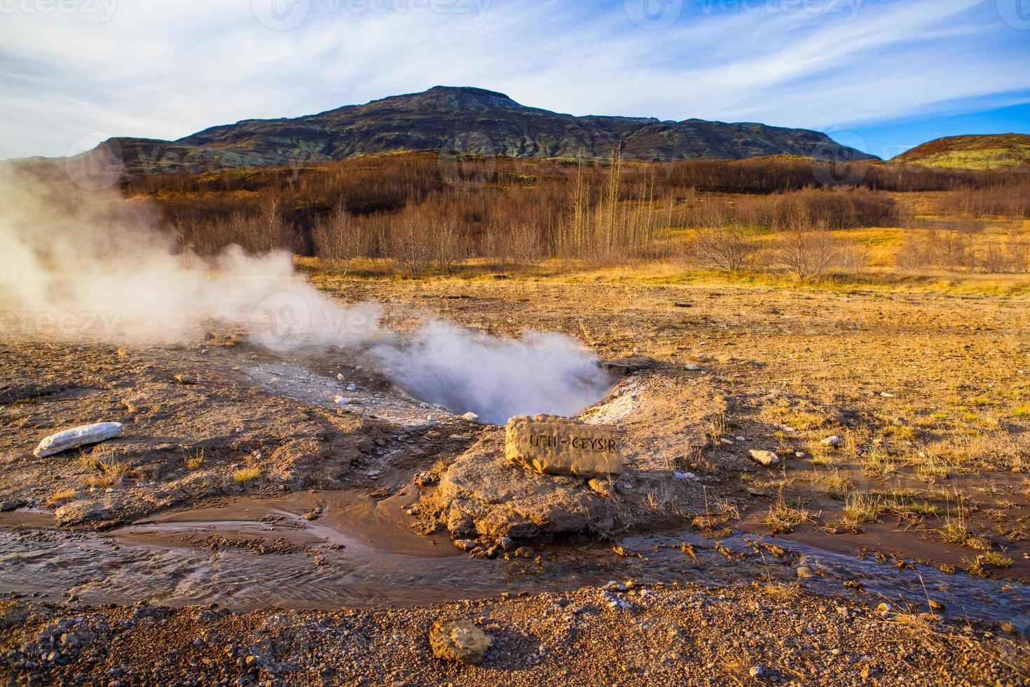 Strokkur, one of the most famous geysers located in a geothermal area beside the Hvita River in the southwest part of Iceland, erupting once every 6-10 minutes photo