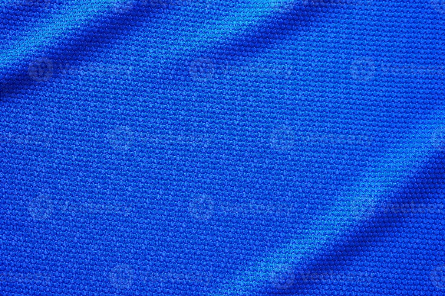 Blue football jersey clothing fabric texture sports wear background, close up top view photo